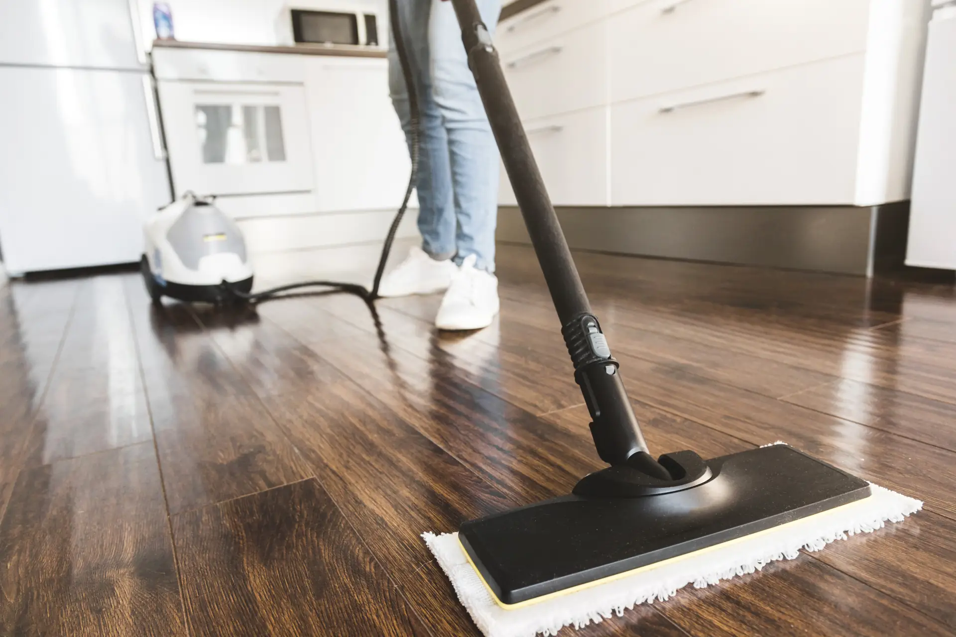 Person cleaning hardwood floors