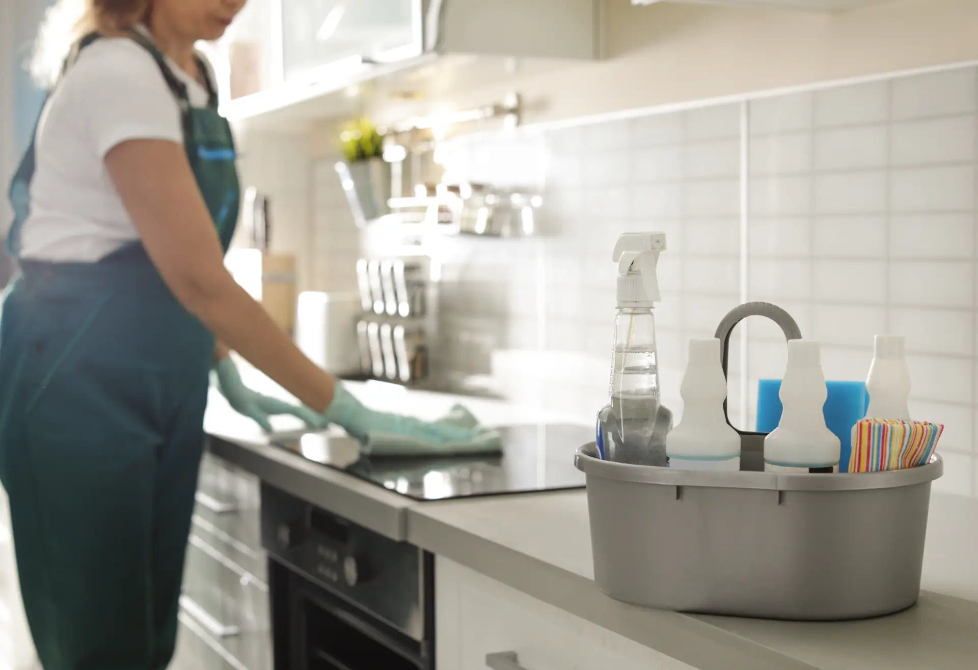 Person cleaning a kitchen countertop